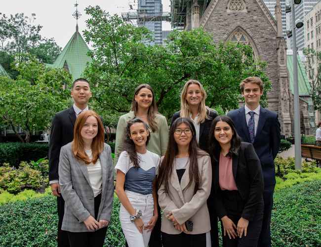 Gildan’s Corporate Head Office interns in Montreal are smiling at the camera while standing outside.