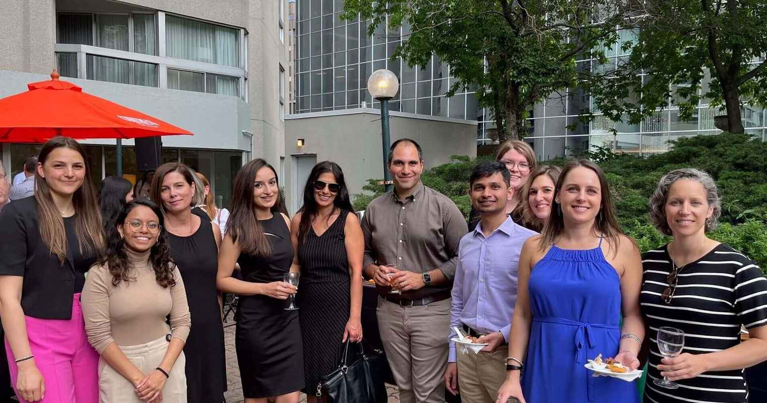 Un groupe d’employés de Gildan du siège social de Montréal sourient à l’extérieur.